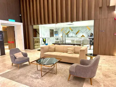 a living room with a couch and two chairs and a table at Kualalumpur Quill Residences Suites By KLCC in Kuala Lumpur