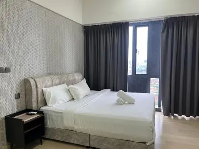 a hotel room with a bed and a window at Aurora Suites At Star Residences in Kuala Lumpur