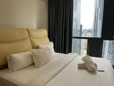 a hotel room with a bed with a large window at Aurora Suites At Star Residences in Kuala Lumpur