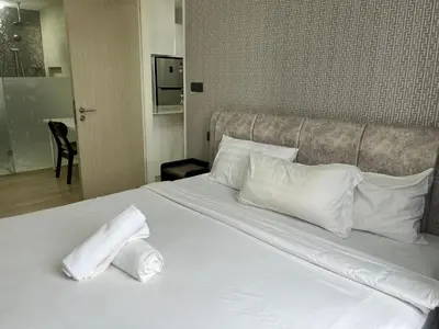a white bed with two pillows on top of it at Aurora Suites At Star Residences in Kuala Lumpur