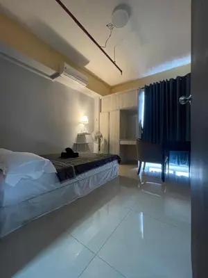 a bedroom with a bed and a desk and a piano at Nour Homestay KLCC View - COMFORT in Kuala Lumpur