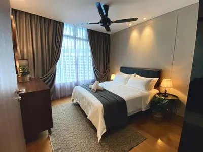 a bedroom with a bed and a ceiling fan at Sky Suites KLCC Luxury Cozy Suites in Kuala Lumpur