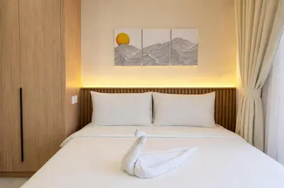 a bedroom with a bed with a white pillow on it at Neu Suites Kuala Lumpur By Vglory Home in Kuala Lumpur