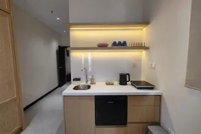 a small kitchen with a sink and a counter at Neu Suites Kuala Lumpur By Vglory Home in Kuala Lumpur