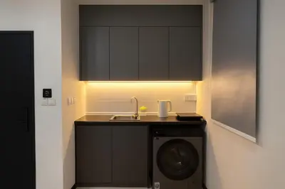 a kitchen with a sink and a washing machine at Neu Suites Kuala Lumpur By Vglory Home in Kuala Lumpur