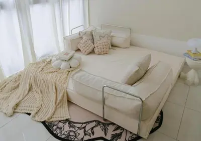 a large white bed with pillows on it in a room at Cozy Cityscape Homestay in KL City Center 1-5pax in Kuala Lumpur