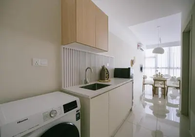 a kitchen with a sink and a dishwasher in it at Cozy Cityscape Homestay in KL City Center 1-5pax in Kuala Lumpur