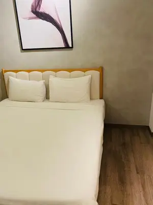 a bedroom with a white bed with two pillows at agile residence at gorgeous luxury in Kuala Lumpur
