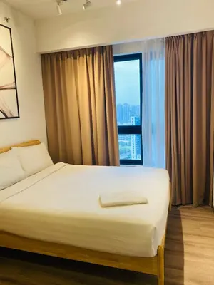 a bedroom with a bed and a large window at agile residence at gorgeous luxury in Kuala Lumpur