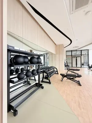 a gym with a row of dumbbells and weights at Luxury Home At Axon Residence Bukit Bintang KLCC Pavilion in Kuala Lumpur