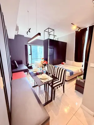 a living room with a bed and a dining room at Luxury Home At Axon Residence Bukit Bintang KLCC Pavilion in Kuala Lumpur
