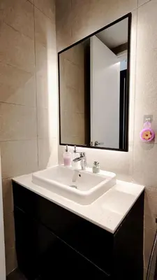 a bathroom with a white sink and a mirror at Axon in Kuala Lumpur