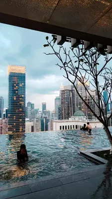 two people swimming in a swimming pool in a city at Axon in Kuala Lumpur