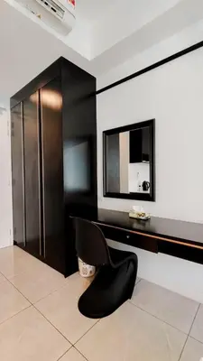 a room with a black desk and a mirror at Axon in Kuala Lumpur