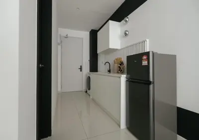 a kitchen with a black and white refrigerator at Cool Cityscape Homestay in KL City Center 1-5pax in Kuala Lumpur