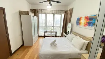 a bedroom with a bed with a teddy bear on it at Regalia skypool8 in Kuala Lumpur