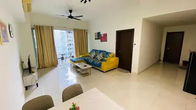 a living room with a yellow couch and a table at Regalia skypool8 in Kuala Lumpur