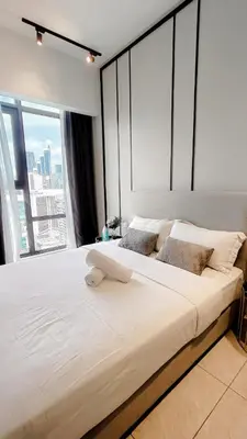 a large bed in a room with a large window at Axon premier suites, Pavilion Bukit bingtang, KL Tower in Kuala Lumpur