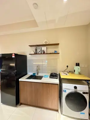 a kitchen with a black refrigerator and a sink at Majestic Residence klcc by Stay Suites in Kuala Lumpur