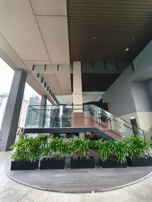 a lobby with a bunch of plants in a building at AXON RESIDENCE by DREAM HOME in Gua Sai