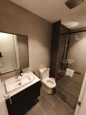 a bathroom with a toilet and a sink and a shower at AXON RESIDENCE by DREAM HOME in Gua Sai