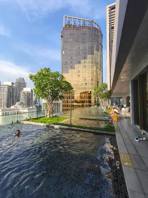 a swimming pool in front of a tall building at AXON RESIDENCE by DREAM HOME in Gua Sai