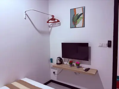a room with a tv and a desk with a tv at Neu Suites Apartment - Cozy Modern Stay near KLCC in Kuala Lumpur