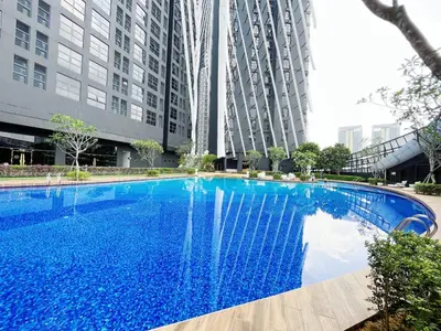 a large blue swimming pool in front of tall buildings at Arte Mont Kiara By Whitedoorz in Kuala Lumpur