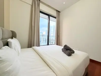 a hotel room with a bed with a bag on it at The Manor Kuala Lampur in Kuala Lumpur