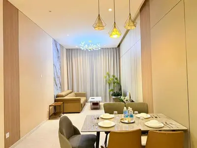 a living room with a dining table and chairs at The Manor Kuala Lampur in Kuala Lumpur