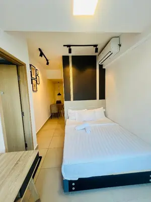 a bedroom with a large white bed in a room at LUXE KLCC SKY LiNE in Kuala Lumpur