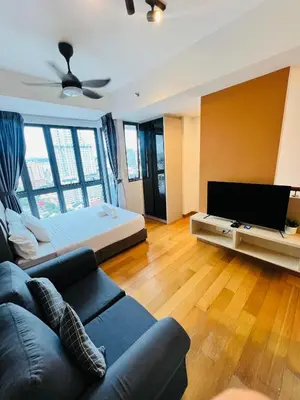 a living room with a couch and a television at LUXE KLCC SKY LiNE in Kuala Lumpur
