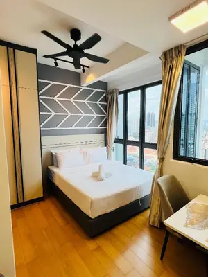 a bedroom with a bed and a ceiling fan at LUXE KLCC SKY LiNE in Kuala Lumpur
