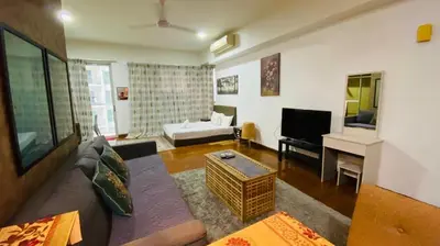 a living room with a couch and a television at Regalia SkyLux Studio in Kuala Lumpur