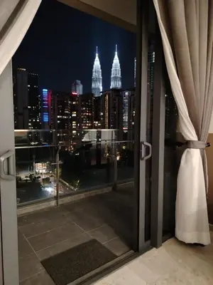 a view of a city skyline from a window at The MANOR INFINITY Suites KLCC in Kuala Lumpur