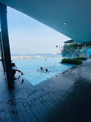 a group of people swimming in a swimming pool at The MANOR INFINITY Suites KLCC in Kuala Lumpur