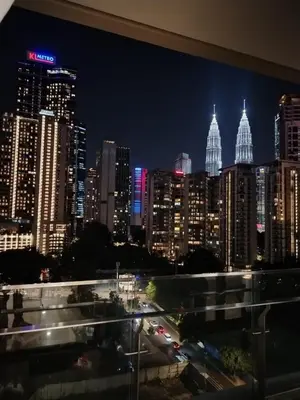 a view of a city skyline at night at The MANOR INFINITY Suites KLCC in Kuala Lumpur
