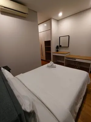 a large white bed in a room with a mirror at Sky Suites KLCC by Tareen Haven suites in Kuala Lumpur