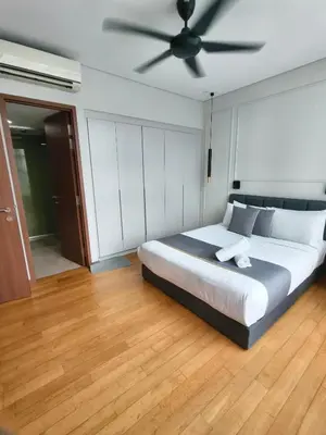 a bedroom with a bed with a ceiling fan at Sky Suites KLCC by Tareen Haven suites in Kuala Lumpur