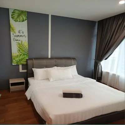a bedroom with a large white bed with a black headboard at KLCC Sky suites apartment bukit bintang in Kuala Lumpur