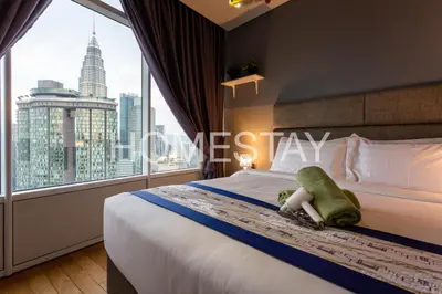 a bedroom with a bed with a large window at VORTEX SUITES KLCC By HOMESTAY in Kuala Lumpur