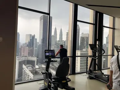a man in an office with a view of the city at IKON SUITE's A X O N BUKIT BINTANG in Kuala Lumpur