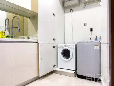 a kitchen with a washing machine and a sink at SOHO SUITES KLCC BY Homestay in Kuala Lumpur