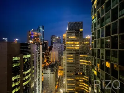 a city skyline at night with illuminated buildings at SOHO SUITES KLCC BY Homestay in Kuala Lumpur