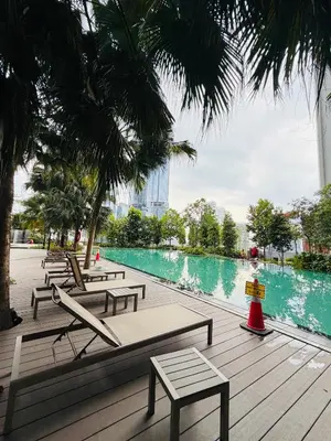 a deck with benches and a swimming pool at Agile Bukit Bintang TRX By Empire Suites in Kuala Lumpur