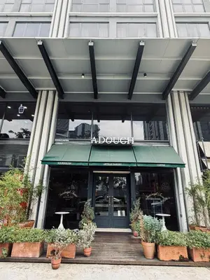 a restaurant with potted plants in front of a building at Agile Bukit Bintang TRX By Empire Suites in Kuala Lumpur