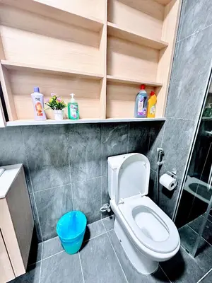 a bathroom with a toilet and a blue stool at The Luxe Colony KLCC By KUALA LUMPUR in Kuala Lumpur