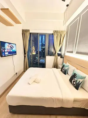a bedroom with a large bed with a window at The Luxe Colony KLCC By KUALA LUMPUR in Kuala Lumpur
