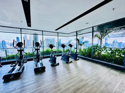 a gym with treadmills and exercise equipment in a building at The Luxe Colony KLCC By KUALA LUMPUR in Kuala Lumpur