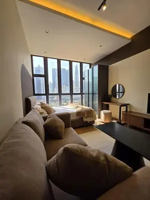 a living room with a couch and a large window at Sky Line Suites KL Podu in Kuala Lumpur